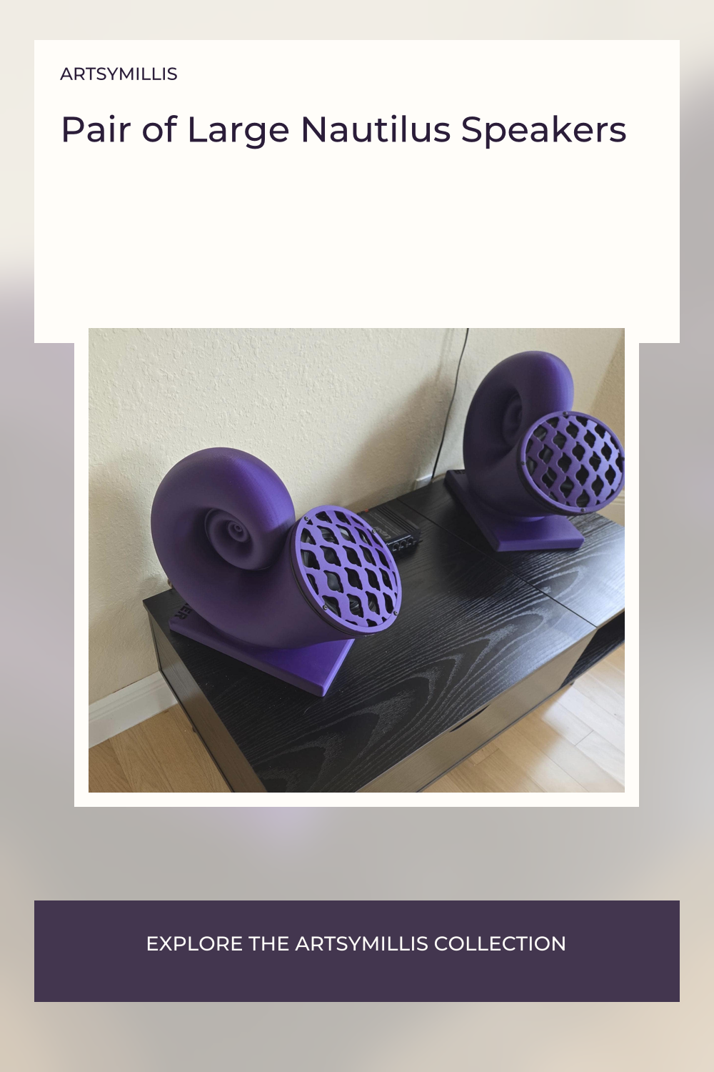 A pair of large, purple nautilus speakers with a grid pattern on the front, placed on a black wooden surface.