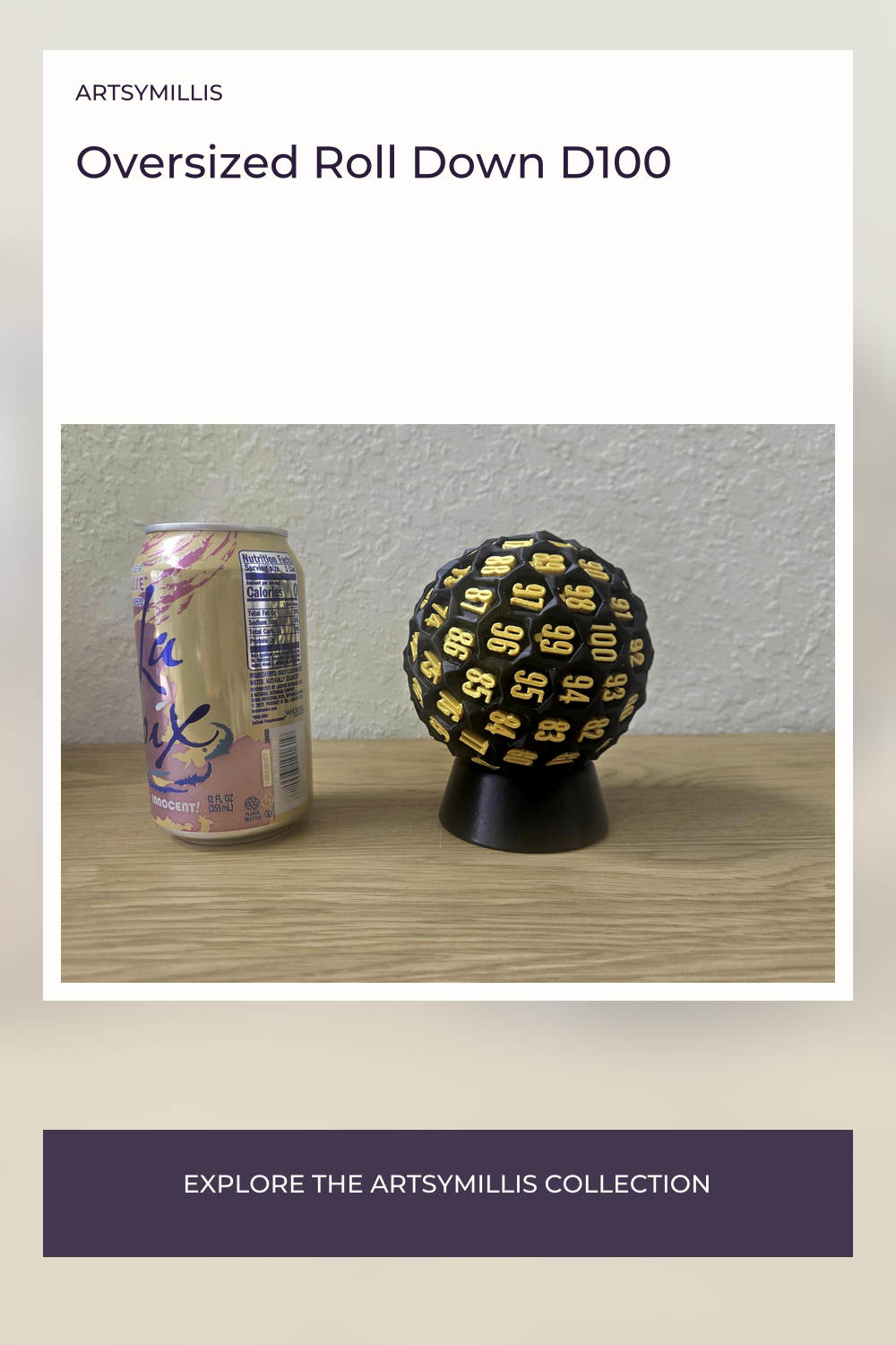 A black and gold oversized roll down D100 dice with numbers 00 to 99 printed on it, placed on a black stand, next to a LaCroû